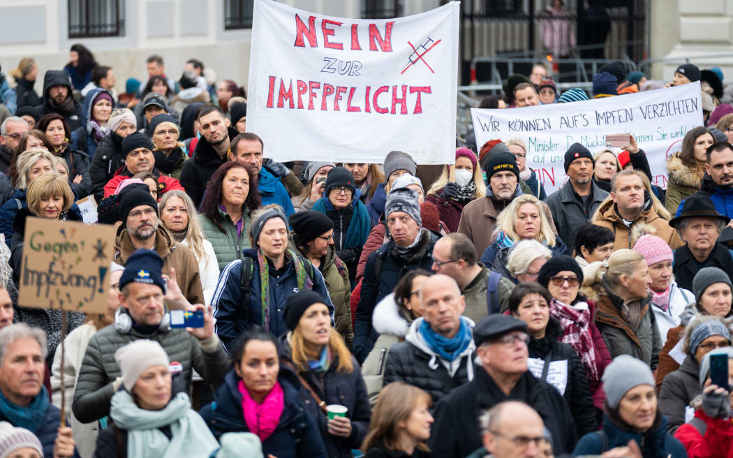 A demonstrator holds a placard reading 'No to compulsory vaccination' during an anti-vaccination protest at the Ballhausplatz in Vienna, Austria, on November 14, 2021.
