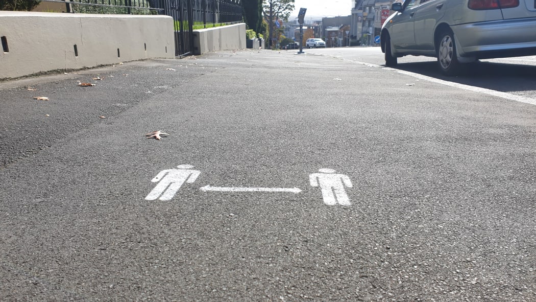 2 metre distance signs on Auckland footpaths on day one of alert level 3 on 28 April.