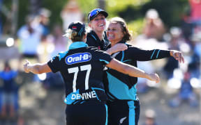 New Zealand captain Sophie Devine and Hannah Rowe celebrate with Suzi Bates after winning the 3rd T20 International against England, 2024.