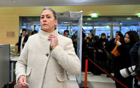Caroline Darian passes through security check as she arrives at the courthouse in Avignon, France, on December 19.