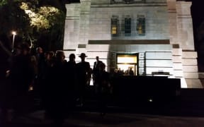 Guests outside the National War Memorial, during the pre-dawn blessing ceremony of the opening of the Pukeahu National War Memorial Park in Wellington.