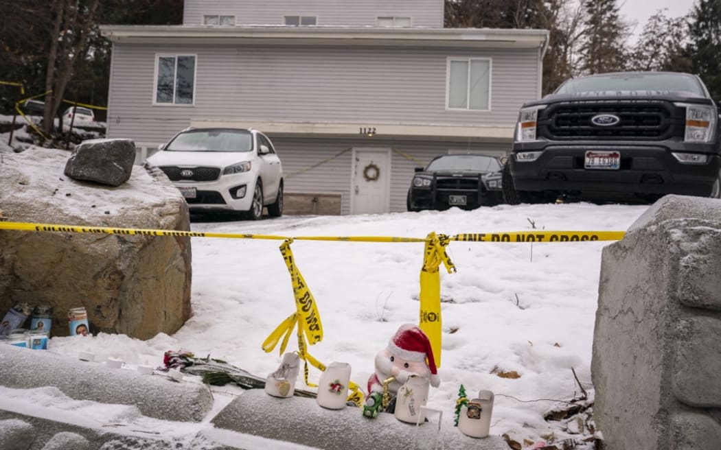 Objects left for a makeshift memorial sit at the site of a quadruple murder in Moscow, Idaho.
