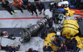Parts of an engine of the ill-fated Lion Air flight JT 610 are recovered from the sea during search operations in the Java Sea.