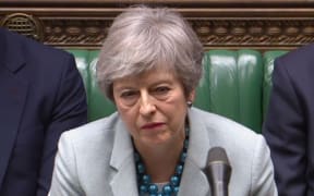 Britain's Prime Minister Theresa May listen as opposition leader Jeremy Corbyn speaks in the House of Commons in London on March 25, 2019 after May outlined the next steps that parliament will take in the Brexit process.