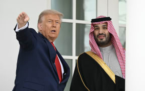 US President Donald Trump and Crown Prince and Prime Minister of the Kingdom of Saudi Arabia Mohammed bin Salman walk down the Colonnade on the way to the Oval Office of the White House in Washington, DC on November 18, 2025. Saudi Crown Prince Mohammed bin Salman arrived at the White House to fanfare and a jet flyover Tuesday, in his first visit to the United States since the 2018 murder of journalist Jamal Khashoggi. (Photo by ANDREW CABALLERO-REYNOLDS / AFP)