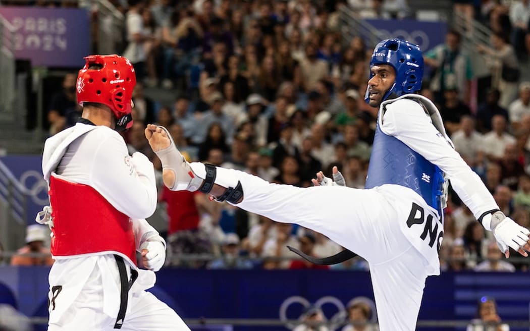 PNG's Gibson Kaogo Mara (blue)  made his Olympic Games debut on Sunday night. Photo: Casey Sims/ONOC