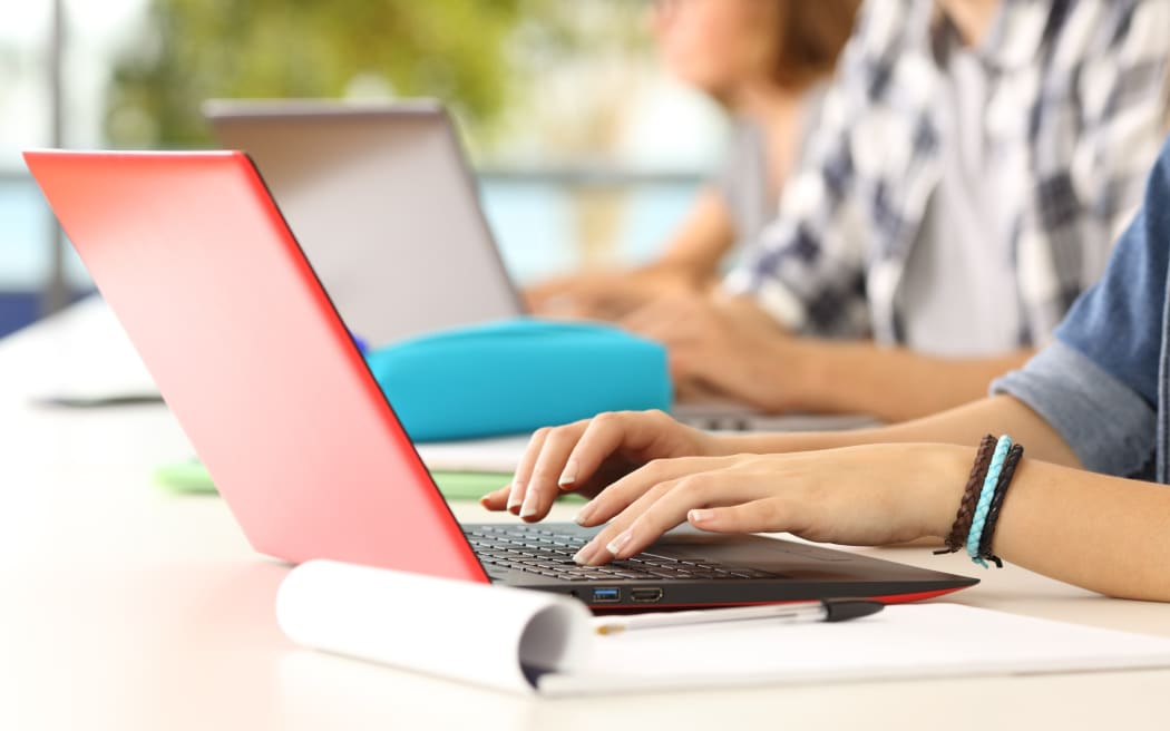 Students working at laptops