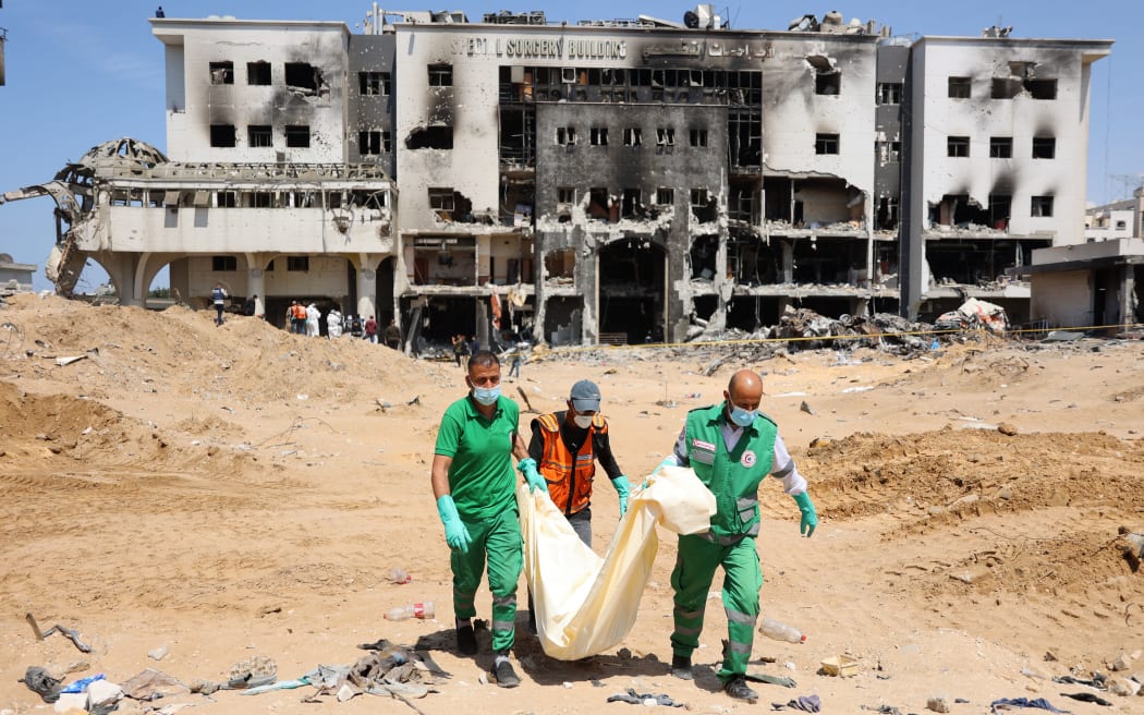 Palestinian forensic and civil defence recover human remains at the grounds of Al-Shifa hospital, Gaza's largest hospital, which was reduced to ashes by a two-week Israeli raid, on April 8, 2024, amid the ongoing conflict between Israel and the Palestinian Hamas militant group. (Photo by AFP)