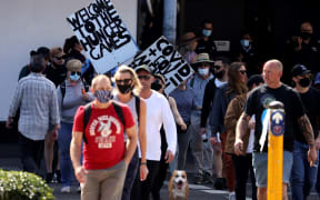 Protestors those with placards gather in Sydney on August 21, 2021, following calls for an anti-lockdown protest rally amid a fast-spreading coronavirus outbreak.