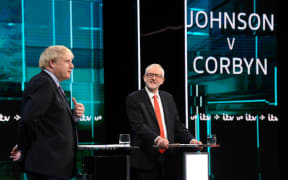 Britain's Prime Minister Boris Johnson (L) and Britain's Labour Party leader Jeremy Corbyn (R) as they debate on the set of "Johnson v Corbyn: The ITV Debate" in Salford, north-west England. - Britain will go to the polls on December 12, 2019 to vote in a pre-Christmas general election.