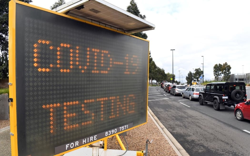 A long queue of cars wait at a drive-through COVID-19 testing site located in a shopping centre carpark in Melbourne.