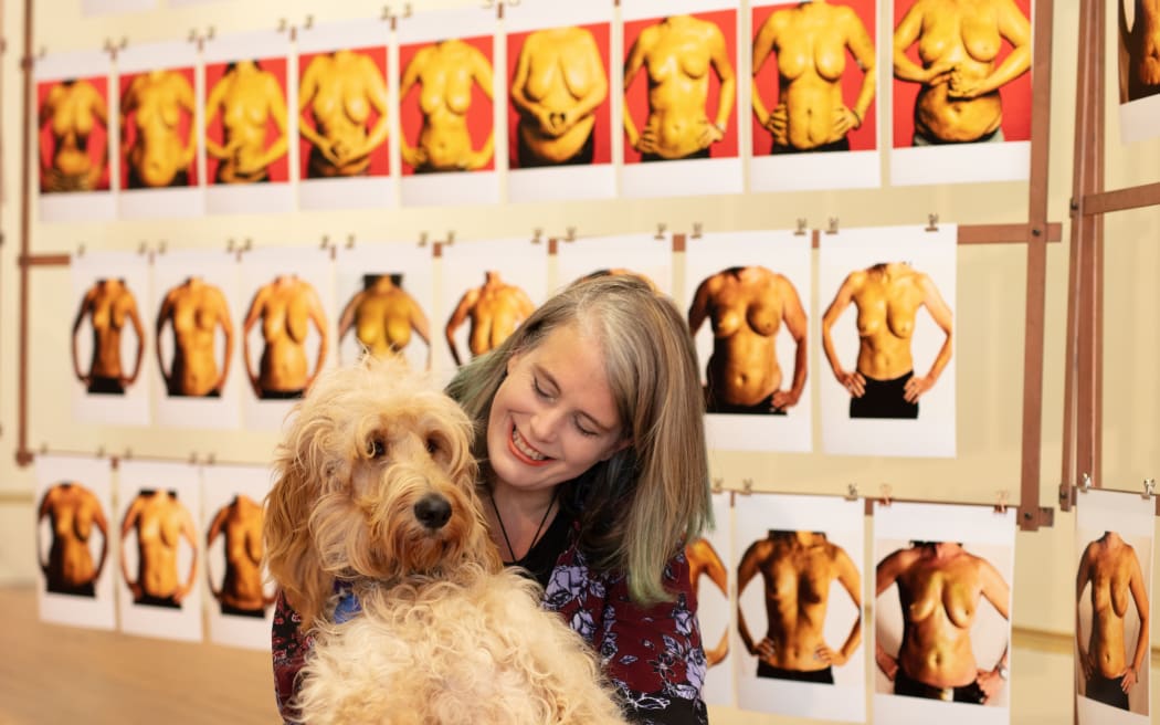 Mandi Lynn at The Every Body is a Treasure exhibition with her dog Gritty