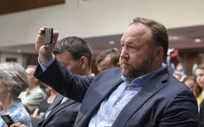 "Infowars" host Alex Jones makes his own recording as he attends the United States Senate Select Committee on Intelligence hearing "to examine foreign influence operations' use of social media platforms" on Capitol Hill in Washington, DC.