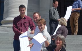 Catherine Delahunty (front) with part of the list of 12,000 names supporting the call for swimmable freshwater.