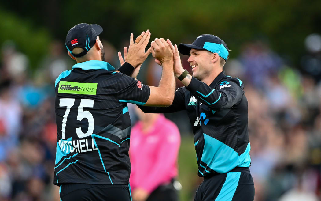 Daryl Mitchell and Lockie Ferguson celebrate a wicket.