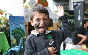 In the concourse of Westpac stadium hundreds of stalls were set up, some painting tā moko on children's faces.