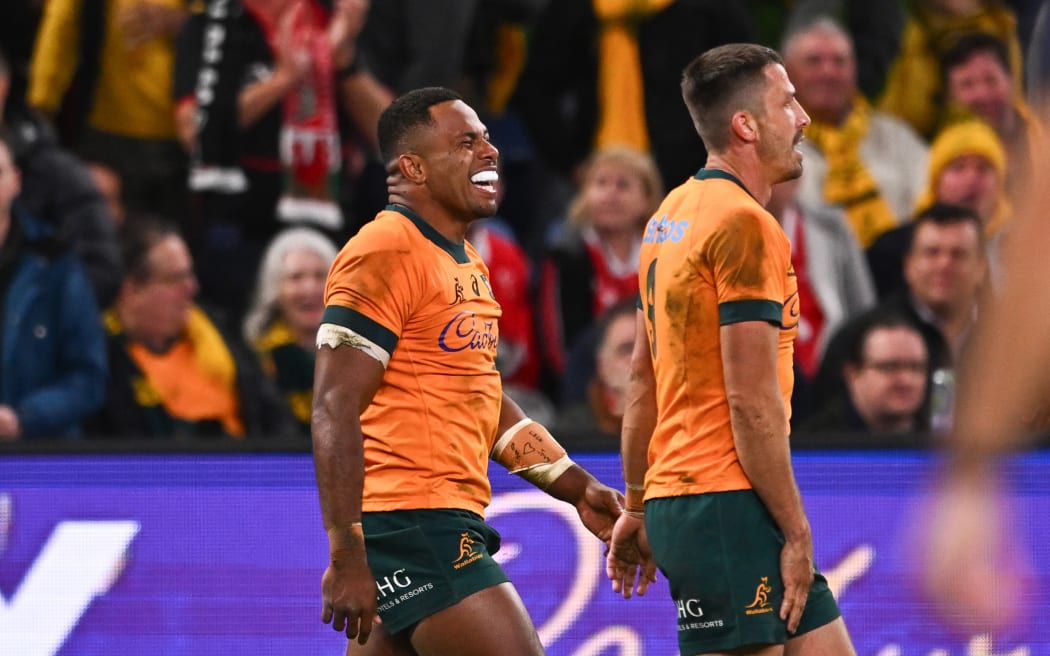 Filipo Daugunu of the Wallabies (L) after scoring a try against Wales.