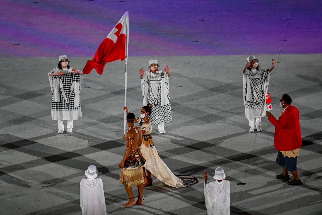 Malia Paseka and Pita Taufatofua carry the Tongan flag during the Tokyo 2020 Olympics Opening Ceremony.