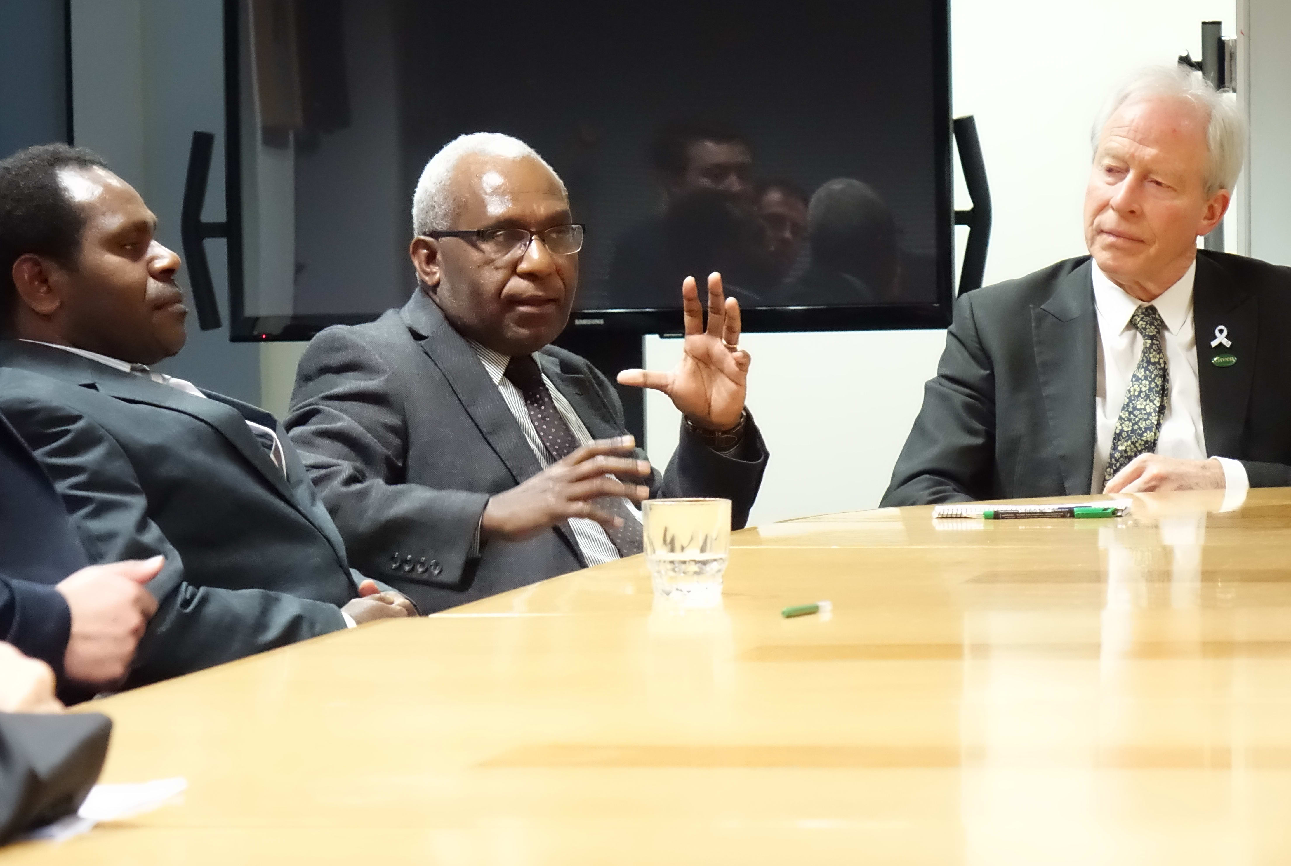 The secretary-general of the United Liberation Movement for West Papua, Octo Mote (centre) talks to New Zealand MPs, including Steffan Browning (right).