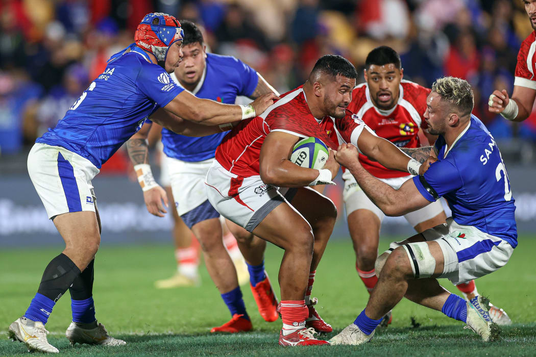 Tonga's Siua Maile is tackled during the first leg of their World Cup qualifying playoff against Samoa.