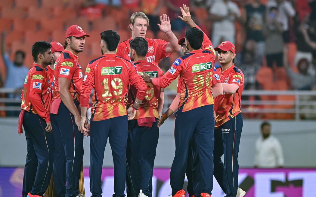 Punjab Kings players congratulates Kyle Jamieson, centre, after he took the wicket of Royal Challengers Bengaluru's Virat Kohli during the Indian Premier League (IPL) T20 qualifier at Chandigarh on 29 May 2025.