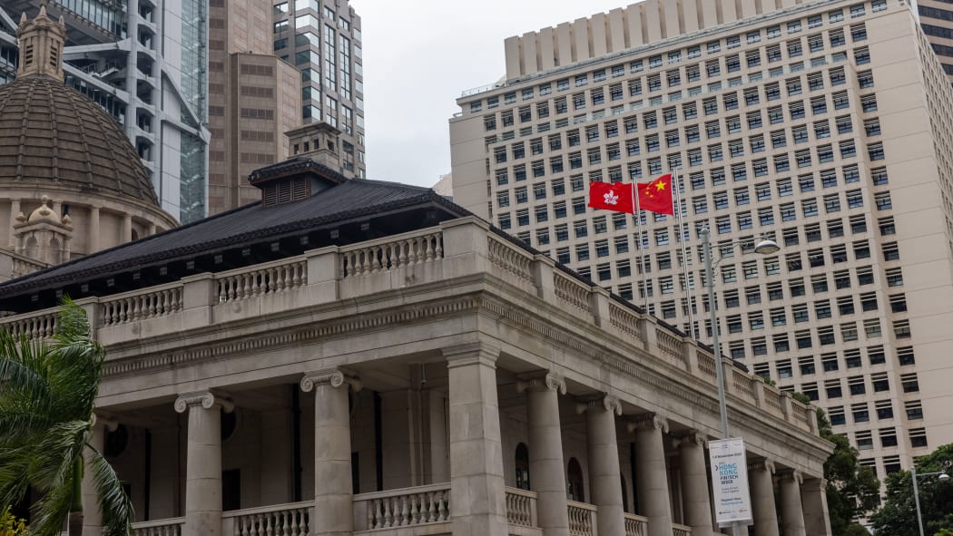 Peoples Republic of China flag and the Hong Kong SAR flag fly above the Court of Final Appeal   in Hong Kong, China, on October 12, 2021.