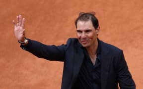 Former Spanish player Rafael Nadal waves to the spectators at the end of a ceremony honouring his career on Court Philippe-Chatrier during the French Open tennis tournament at Roland-Garros, 25 May 2025.