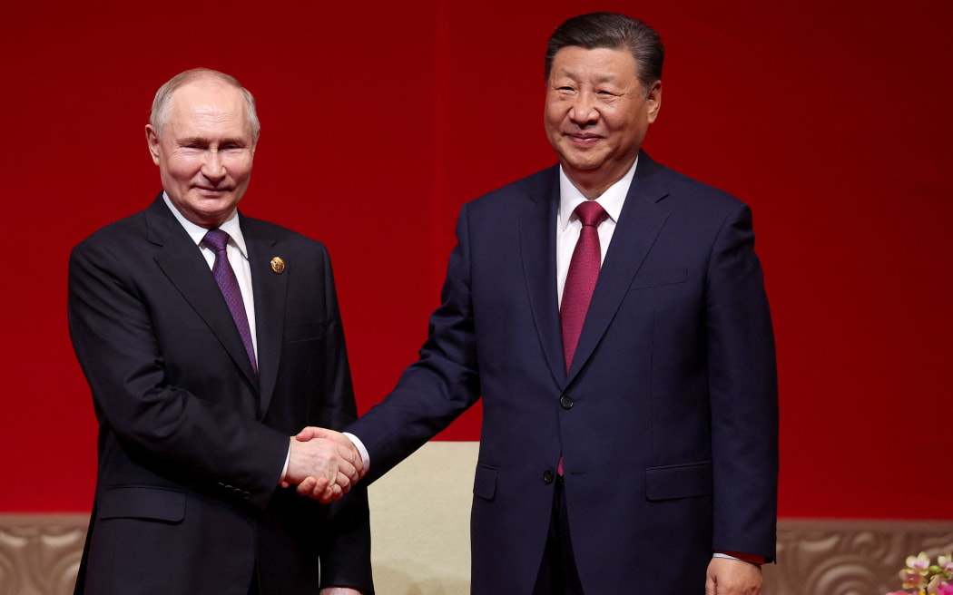 In this pool photograph distributed by the Russian state agency Sputnik, Russia's President Vladimir Putin and China's President Xi Jinping attend a concert marking the 75th anniversary of the establishment of diplomatic relations between Russia and China and opening of China-Russia Years of Culture at the National Centre for the Performing Arts in Beijing on May 16, 2024. (Photo by Alexander RYUMIN / POOL / AFP) / ** Editor's note : this image is distributed by Russian state owned agency Sputnik **
