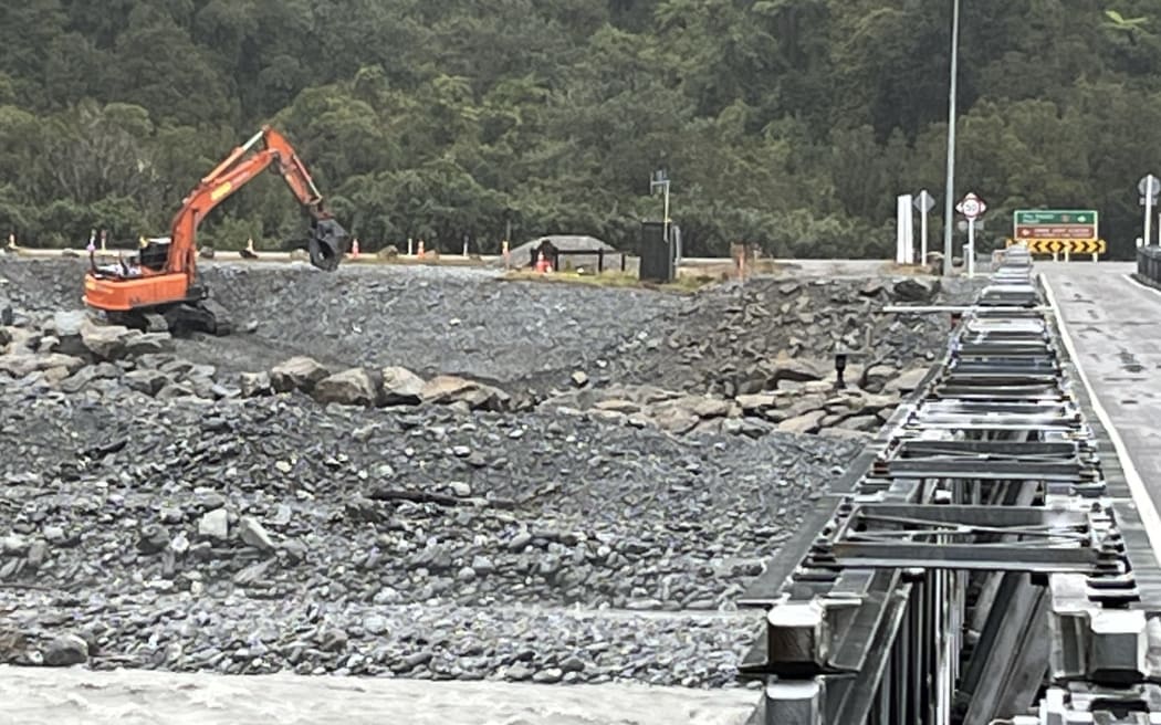 Looking upstream from the Waiho River Bridge work underway today on part of the stage one project at Franz Josef Glacier to protect the southern approach to the bridge with new 'rip rap' rockwork.