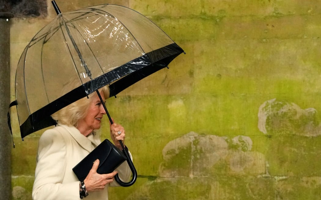 Britain's Queen Camilla holds her umbrella as she arrives for a Musical Evening at Salisbury Cathedral, in Salisbury, England, on February 8, 2024, to celebrate the work of local charities. (Photo by Kirsty Wigglesworth / POOL / AFP)