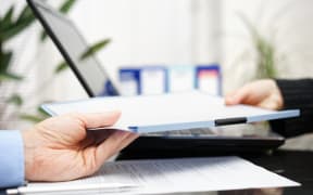 businessman and businesswoman are exchanging document or contract
