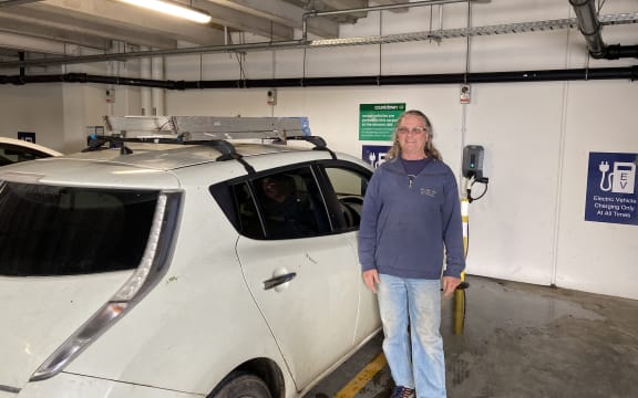 Sparky Robbie Hannaford stands next to his Nissan Leaf on Waiheke Island.