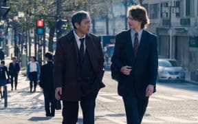 Detective Katagiri (Ken Watanabe) offering a tip to journalist Jake Adelstein (Ansel Elgort).