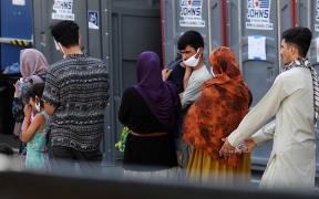 Afghan refugees arrive at a processing center in Chantilly, Virginia, on August 23, 2021, after arriving on a flight at Dulles International Airport.