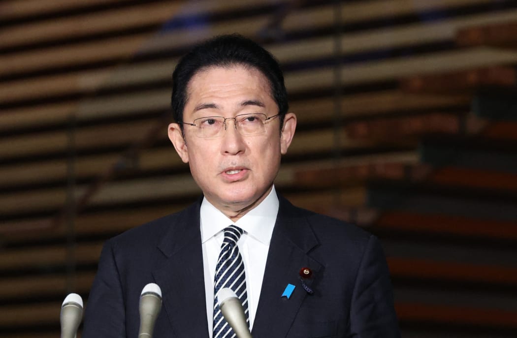 Japanese Prime Minister Fumio Kishida speaks to reporters after the Lower House approved a record 107.60 trillion yen ($900 billion) budget for fiscal 2022 at the prime minister's office in Tokyo on March 22, 2022.