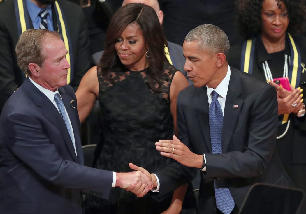 President Barack Obama and first lady Michelle Obama embrace former U.S. President George W. Bush