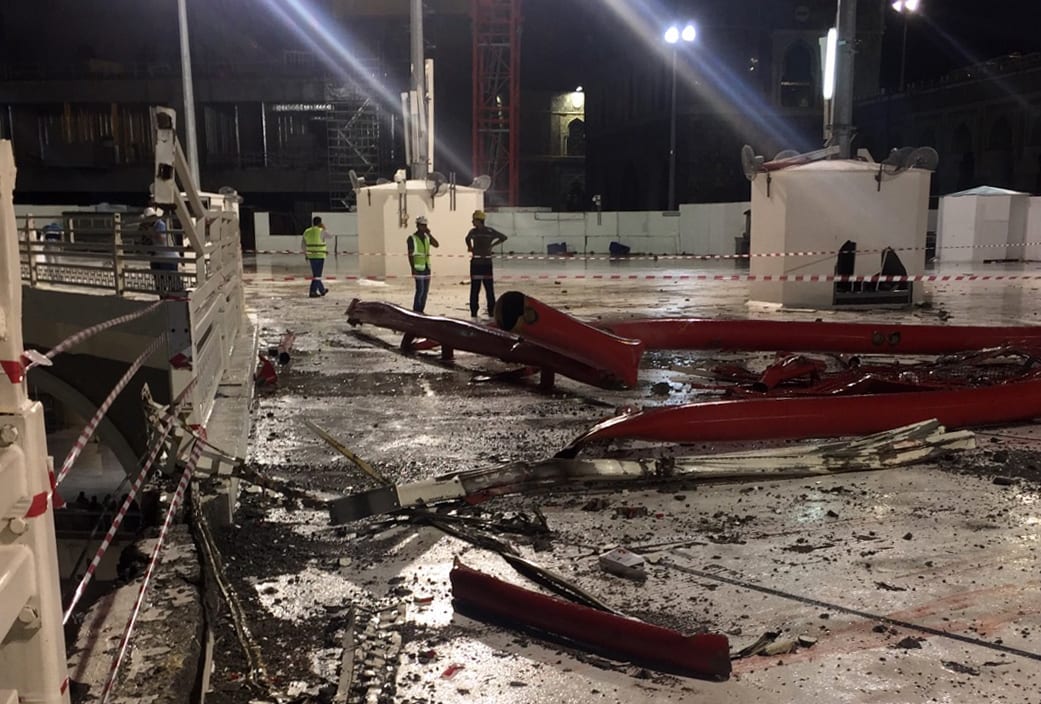 Emergency teams stand next to a construction crane after it crashed into the Grand Mosque of Saudi Arabia's holy Muslim city of Mecca on 11 September 2015.
