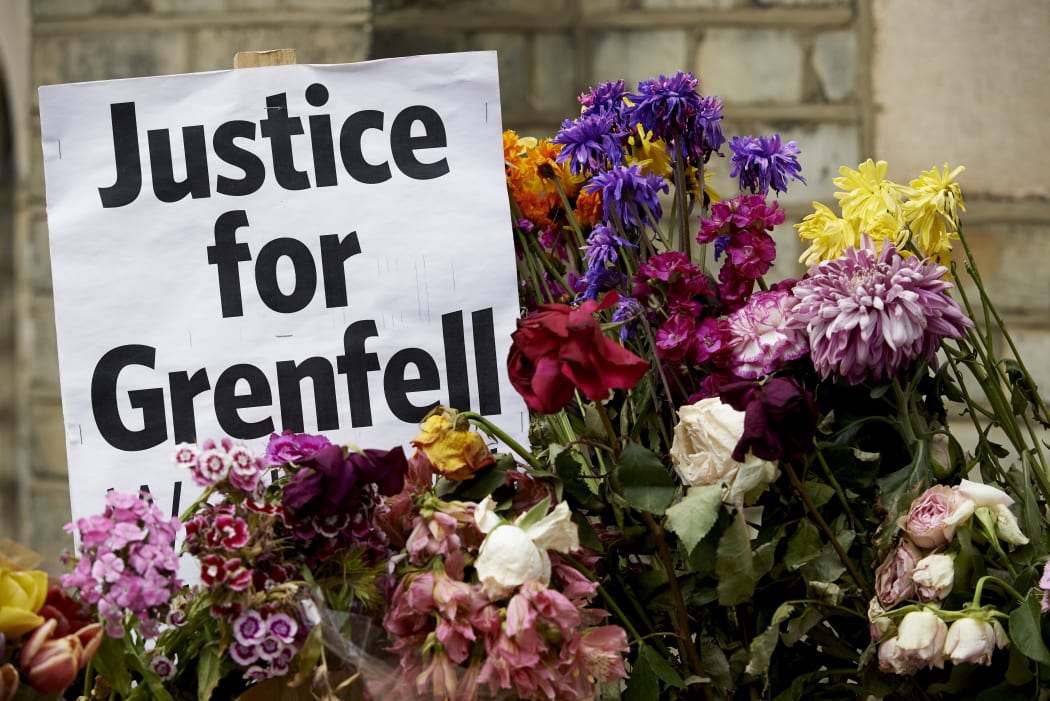 Flowers and messages left by well-wishers in tribute to the victims of the June 14 Grenfell Tower block are pictured near the scene of the fire in North Kensington, west London on June 22, 2017.