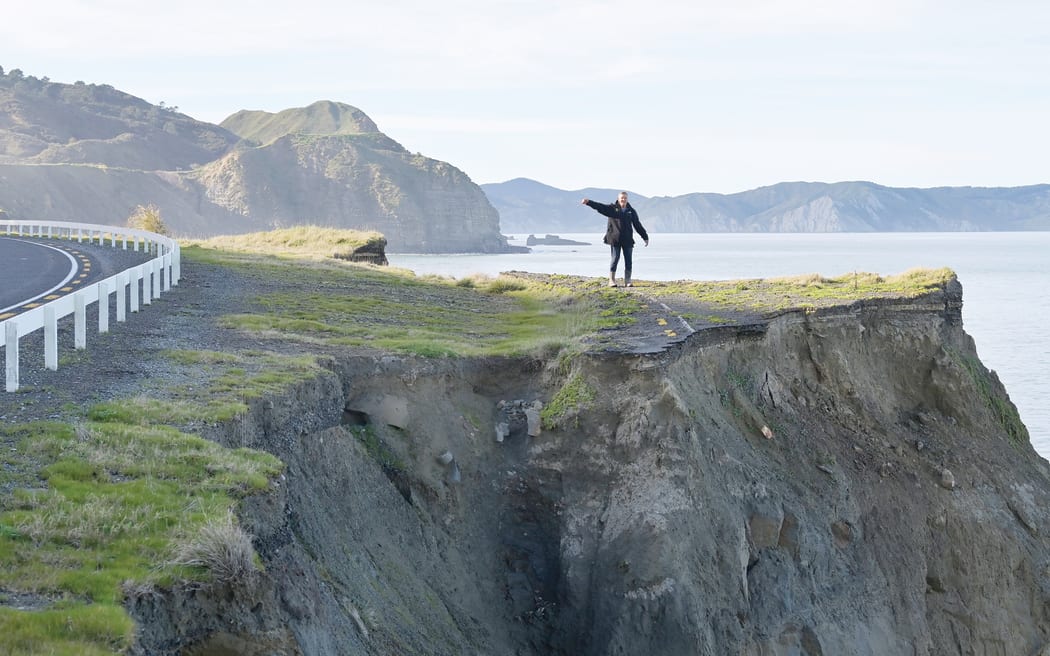 Māhia resident Merv Goodley stands on what used to be the centre of Nuhaka Opoutama Road, but is now a precarious cliff’s edge.