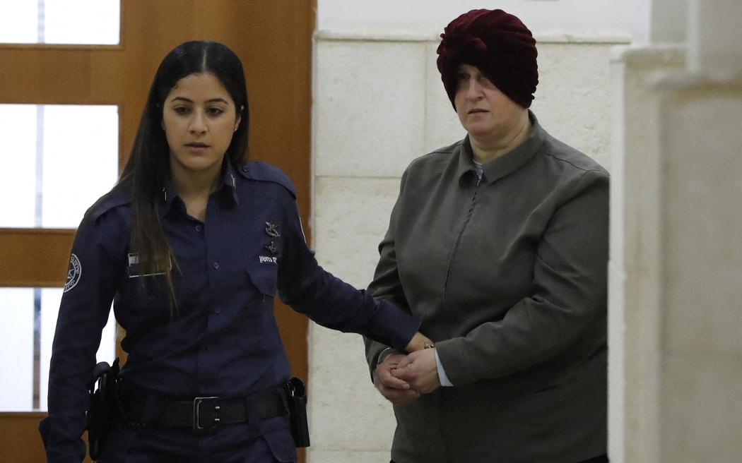 (FILES) Malka Leifer, a former Australian teacher accused of dozens of cases of sexual abuse of girls at a school, arrives for a hearing at the District Court in Jerusalem on February 27, 2018. An ex-headmistress who sexually abused two sisters at an Australian Jewish school, before fleeing to Israel then being extradited back, was sentenced on August 24, 2023 to 15 years in jail. Sentencing judge Mark Gamble said Malka Leifer abused her position within Melbourne's ultra-orthodox community and her "insidious offending" had scarred the sisters for life. (Photo by AHMAD GHARABLI / AFP)