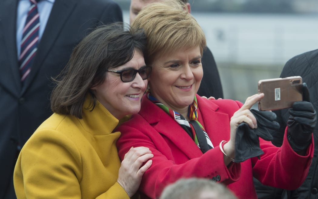Scottish National Party (SNP) leader and Scotland's First Minister Nicola Sturgeon (R) takes a selfie with Margaret Ferrier, SNP MP for Rutherglen and Hamilton West as she meets with SNP's newly elected MPs in Dundee,