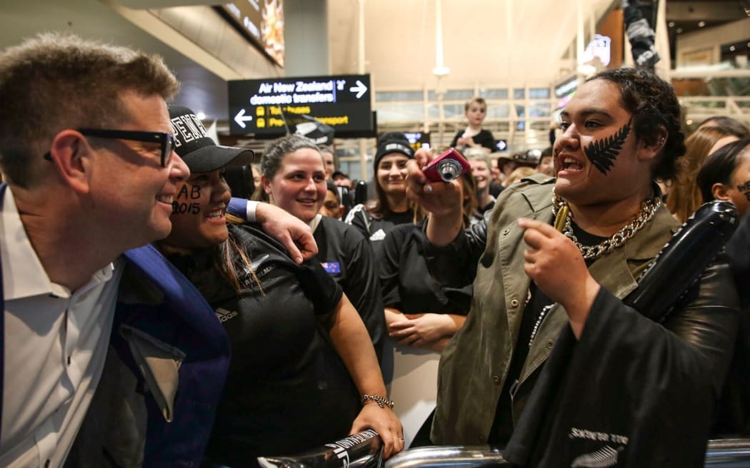 RNZ presenter John Campbell with fans at Auckland Airport.