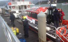A police dive team prepares for a recovery operation.