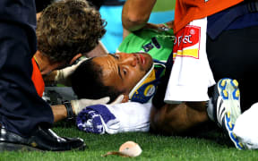 The Highlanders' Buxton Popoalii suffers a head injury during a Super Rugby match.