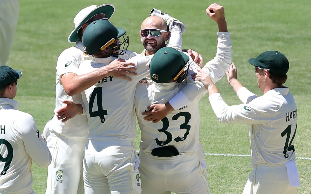 Nathan Lyon of Australia celebrates taking his 400th test wicket during day four of the First Ashes Test between Australia and England at The Gabba.