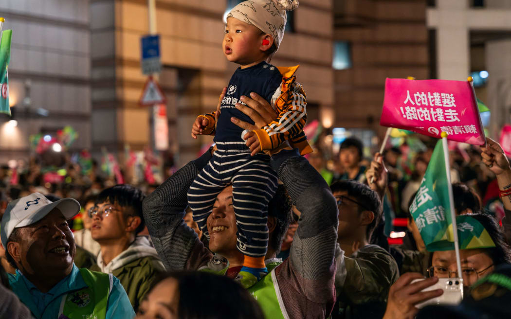 A jubilant crowd of supporters in Taipei celebrated the victory of Lai Ching-Te in Taiwan's presidential election. (Photo by Jimmy Beunardeau / Hans Lucas / Hans Lucas via AFP)