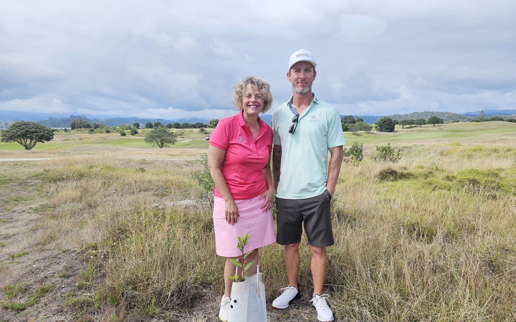Ohope Beach Golf Links club member Kara Ryall and general manager Ryan Walker with the first of the 80 pohutukawa to be planted as part of the restoration project.