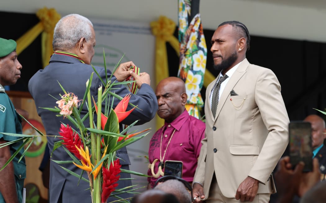 Brian Kaltak about to receive his national honour from Vanuatu President Nikinike Vurobaravu