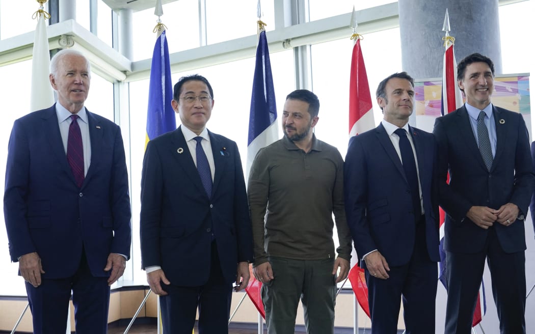 (L to R) US President Joe Biden, Japan's Prime Minister Fumio Kishida, Ukraine's President Volodymyr Zelensky, France's President Emmanuel Macron, Canada's Prime Minister Justin Trudeau pose for a family photo ahead of a working session on Ukraine during the G7 Leaders' Summit in Hiroshima on May 21, 2023. (Photo by Susan Walsh / POOL / AFP)