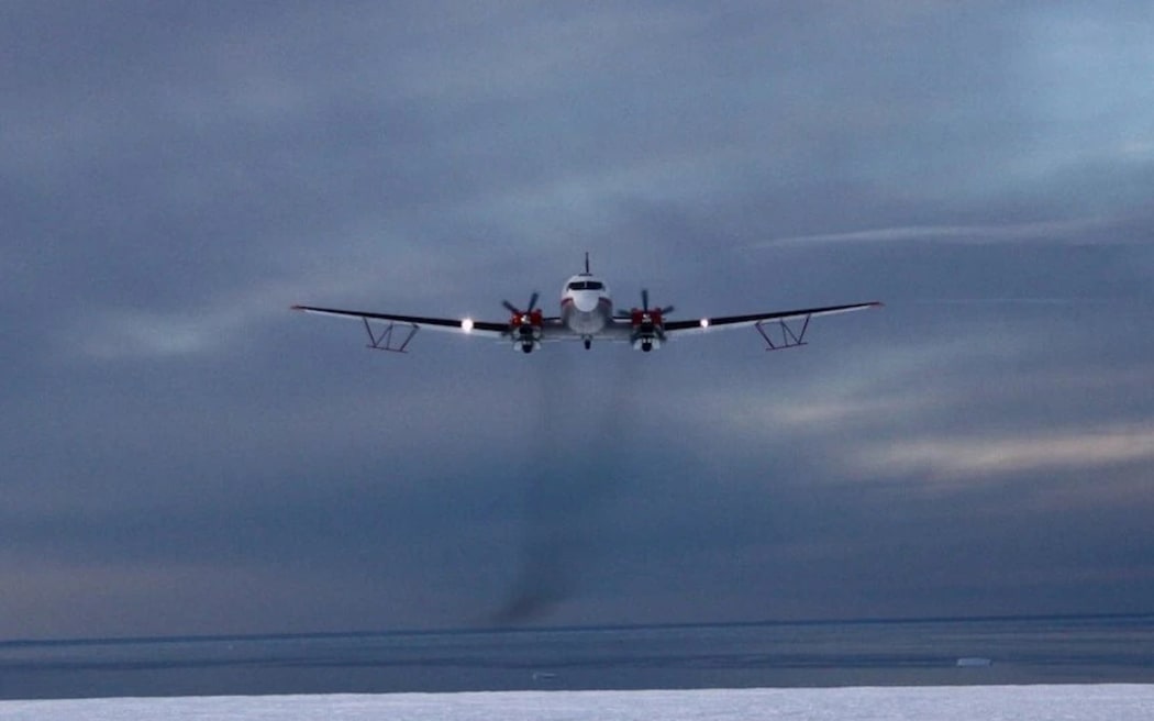 A plane flies over the surface of Antarctica to conduct a survey of the region.